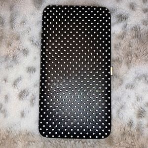 Black and white polkadot hand wallet.